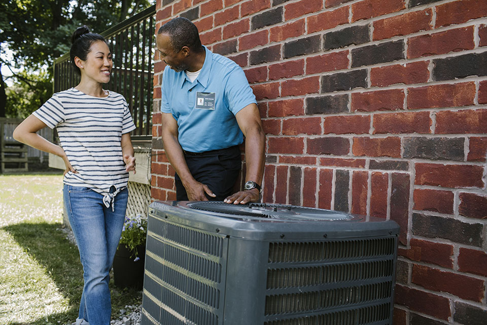 Homeowner receiving advice about her air conditioner from a contractor