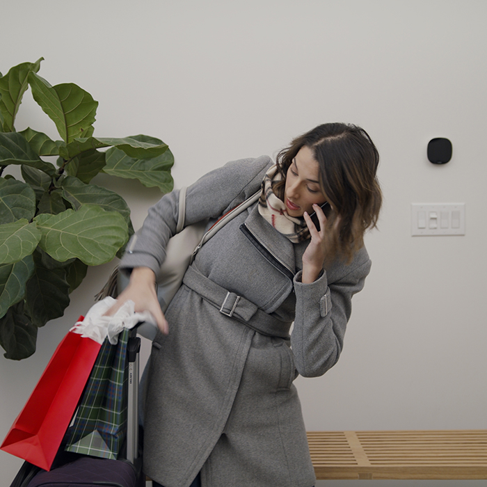 leaving her home for the holidays, but first setting the thermostat lower to save on energy